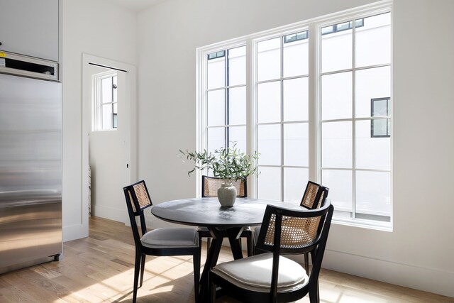 3943 Hawthorne Unit 102, Dallas, TX 75219 - dining space featuring light wood-style flooring and baseboards