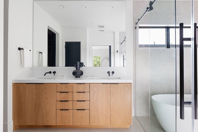 3943 Hawthorne Unit 102, Dallas, TX 75219 - bathroom featuring double vanity, a soaking tub, and a shower stall