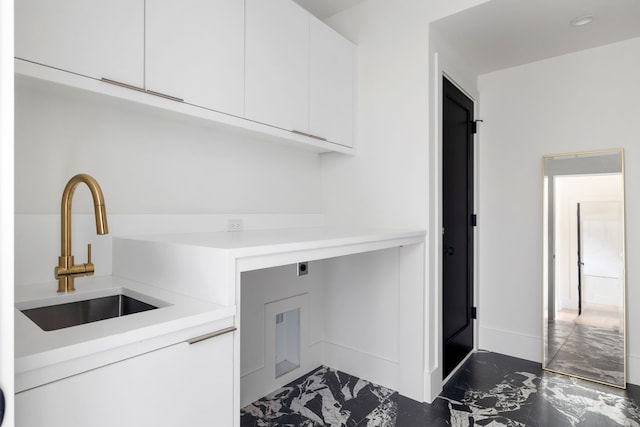 3943 Hawthorne Unit 102, Dallas, TX 75219 - laundry area featuring cabinet space, dark marble finish floors, electric dryer hookup, and baseboards