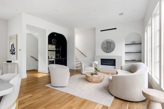 3943 Hawthorne Unit 102, Dallas, TX 75219 - living room with plenty of natural light, built in shelves, wood finished floors, and stairway