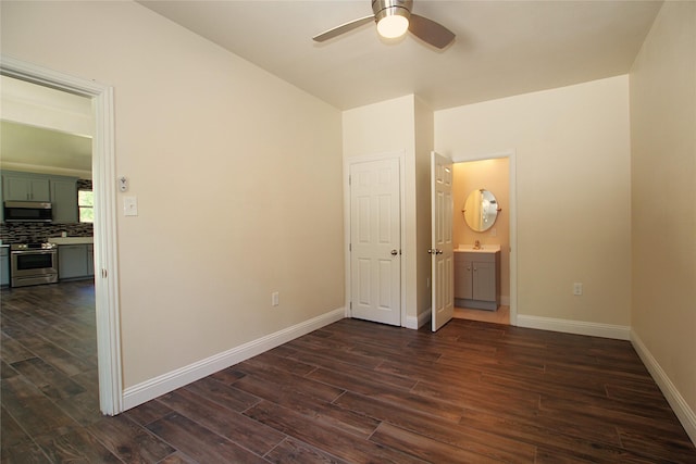 1905 S Walnut St, Sherman, TX 75090 - spare room with dark wood-style flooring, a ceiling fan, and baseboards