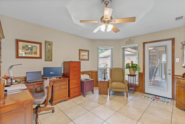 office area with ceiling fan, a textured ceiling, and light tile patterned floors