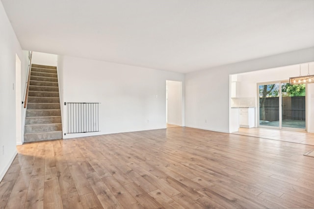4400 Boston Dr, Plano, TX 75093 - empty room with light wood-style flooring, stairway, and baseboards