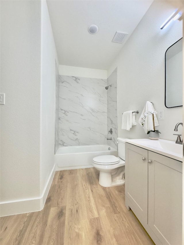 3801 Carpenter Ave, Dallas, TX 75210 - bathroom featuring toilet, vanity, bathtub / shower combination, and wood finished floors