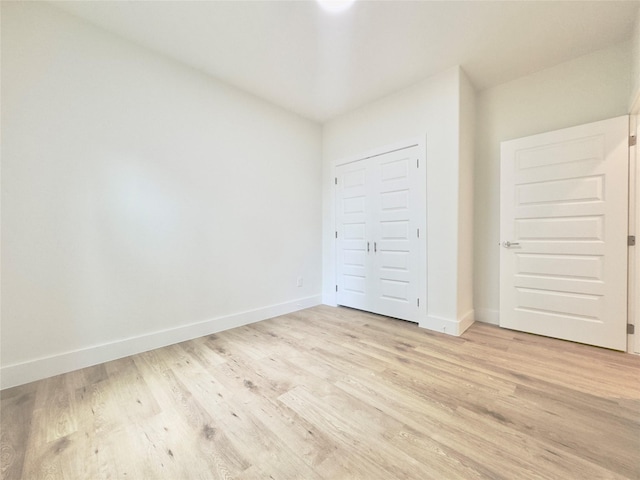 3801 Carpenter Ave, Dallas, TX 75210 - unfurnished bedroom featuring light wood-type flooring and baseboards