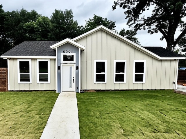 3801 Carpenter Ave, Dallas, TX 75210 - view of front facade featuring roof with shingles, board and batten siding, and a front yard