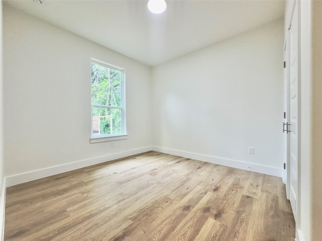 3801 Carpenter Ave, Dallas, TX 75210 - empty room featuring baseboards, light wood-style flooring, and lofted ceiling