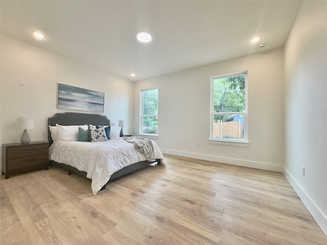 3801 Carpenter Ave, Dallas, TX 75210 - bedroom featuring multiple windows, baseboards, light wood-style floors, and recessed lighting