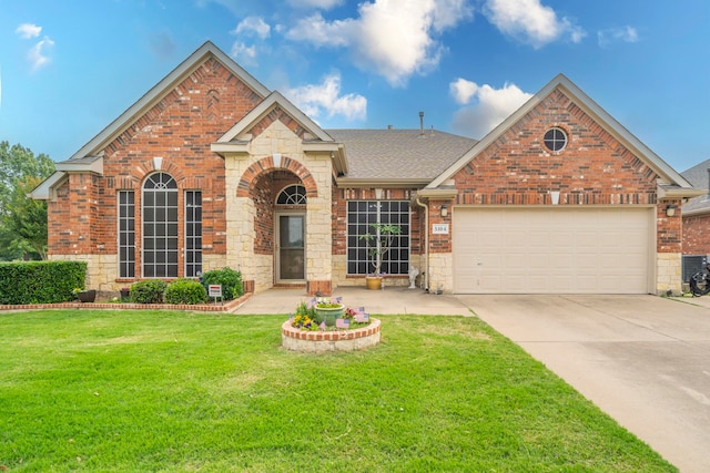 traditional home with brick siding, concrete driveway, a garage, and a front yard