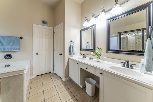 full bath featuring tile patterned floors, double vanity, a garden tub, and baseboards
