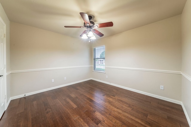 spare room with baseboards, wood finished floors, and ceiling fan