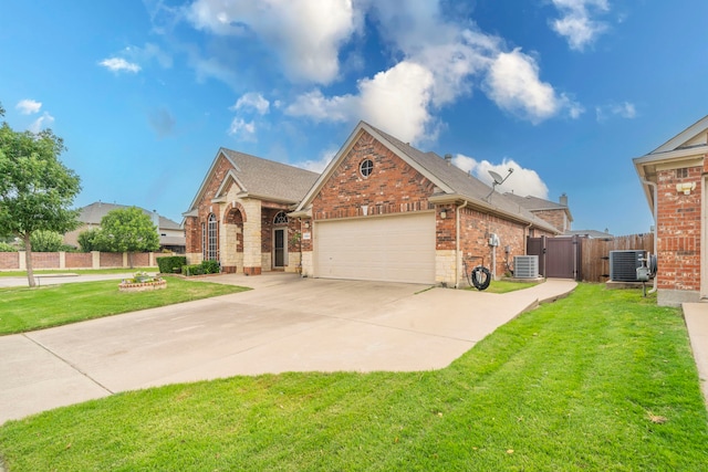 traditional-style house with brick siding, a garage, central air condition unit, and driveway