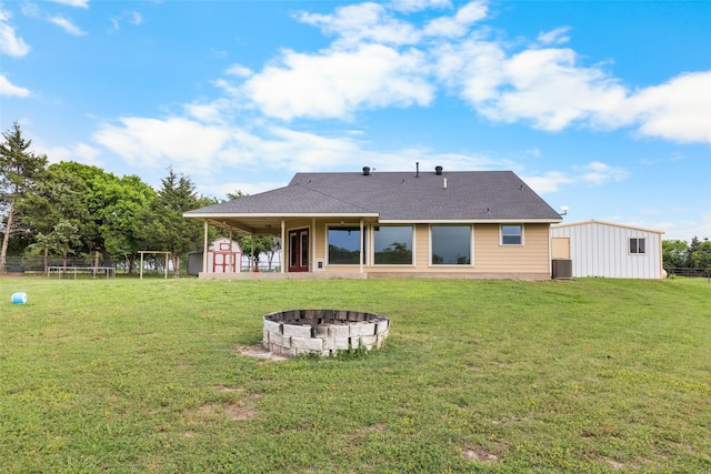 677 County Road 4027, Savoy, TX 75479 - rear view of house with a shed, an outdoor fire pit, an outbuilding, and central air condition unit