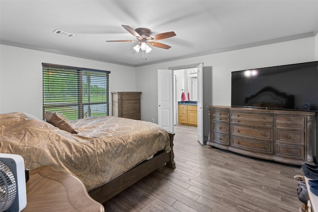 677 County Road 4027, Savoy, TX 75479 - bedroom featuring wood finished floors, a ceiling fan, and ensuite bath
