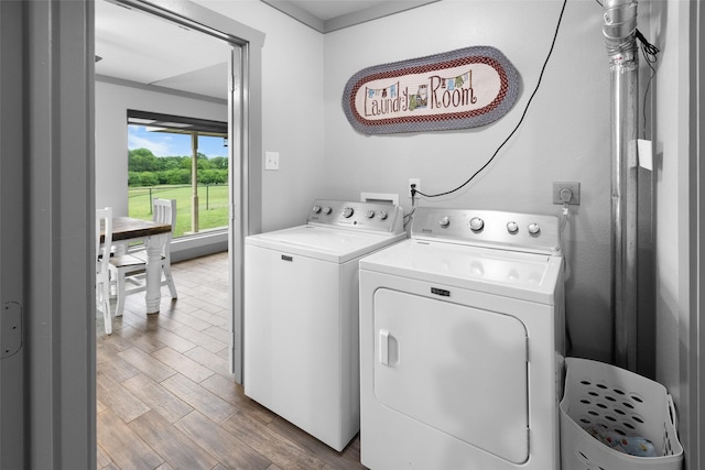 677 County Road 4027, Savoy, TX 75479 - washroom featuring separate washer and dryer and wood finished floors