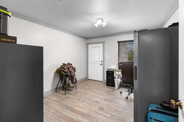 677 County Road 4027, Savoy, TX 75479 - home office with light wood-style flooring and a textured ceiling