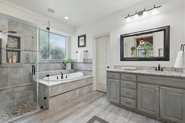 3002 Spring Hill Ln, Highland Village, TX 75077 - full bath with vanity, a garden tub, a shower stall, and wood finished floors