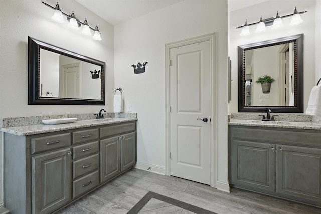 3002 Spring Hill Ln, Highland Village, TX 75077 - full bathroom with double vanity, wood finished floors, and baseboards