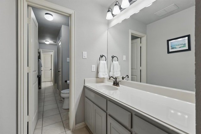 3002 Spring Hill Ln, Highland Village, TX 75077 - bathroom with tile patterned floors, toilet, vanity, and baseboards