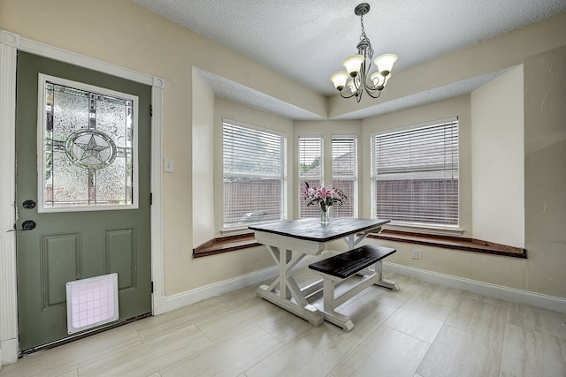 4205 English Ivy Dr, Mckinney, TX 75070 - dining space with a chandelier, baseboards, and a textured ceiling