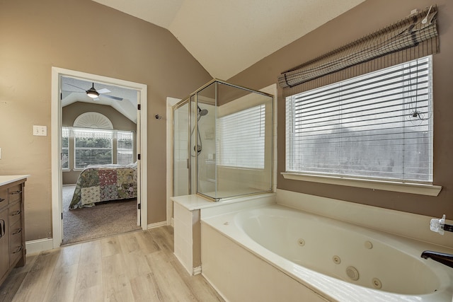 4205 English Ivy Dr, Mckinney, TX 75070 - bathroom featuring vaulted ceiling, wood finished floors, a stall shower, ensuite bathroom, and vanity