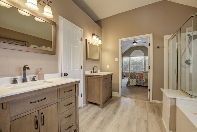 4205 English Ivy Dr, Mckinney, TX 75070 - full bathroom with wood finished floors, a shower stall, a ceiling fan, lofted ceiling, and two vanities