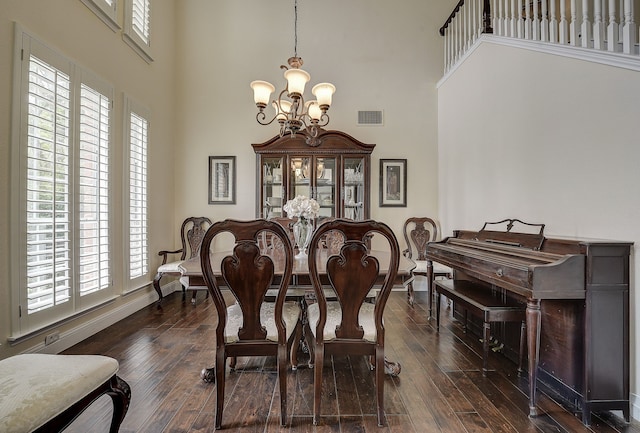 4205 English Ivy Dr, Mckinney, TX 75070 - dining room featuring a chandelier, a towering ceiling, plenty of natural light, and dark wood-type flooring
