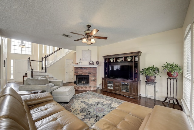 4205 English Ivy Dr, Mckinney, TX 75070 - living area with a ceiling fan, plenty of natural light, wood finished floors, a fireplace, and a textured ceiling