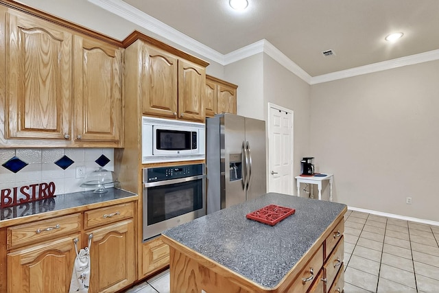 kitchen with appliances with stainless steel finishes, dark countertops, tasteful backsplash, light tile patterned flooring, and ornamental molding