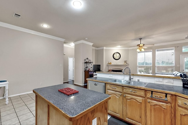 kitchen with a sink, white dishwasher, dark countertops, a center island, and ceiling fan