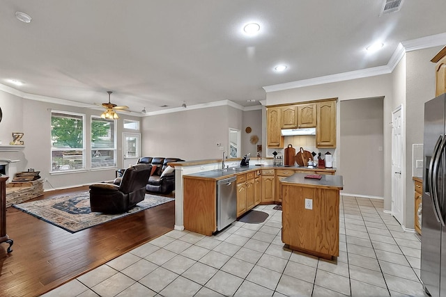 kitchen with open floor plan, a peninsula, appliances with stainless steel finishes, under cabinet range hood, and a ceiling fan