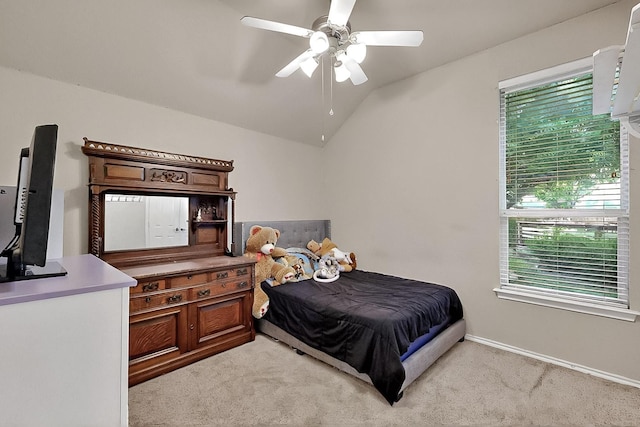 bedroom with light carpet, vaulted ceiling, a ceiling fan, and baseboards
