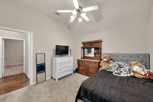 bedroom featuring light carpet, lofted ceiling, a ceiling fan, and baseboards