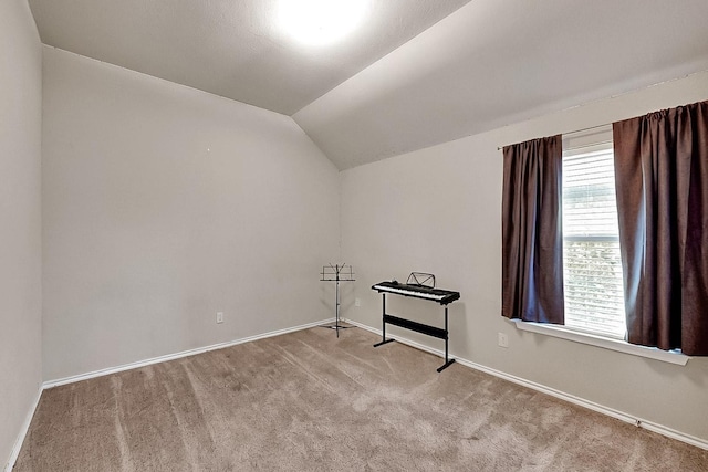 bonus room with carpet floors, lofted ceiling, and baseboards