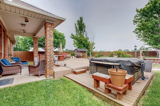 deck featuring a fenced backyard, outdoor lounge area, outdoor dining area, and a hot tub