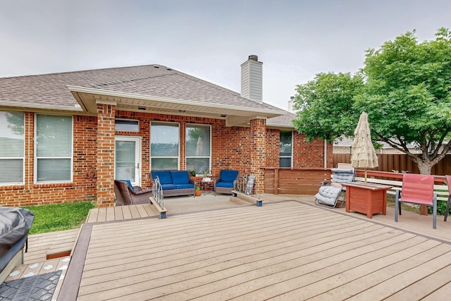 deck with an outdoor living space and fence