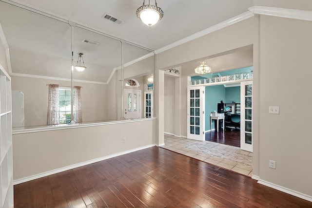 unfurnished dining area featuring hardwood / wood-style floors, lofted ceiling, an office area, crown molding, and baseboards