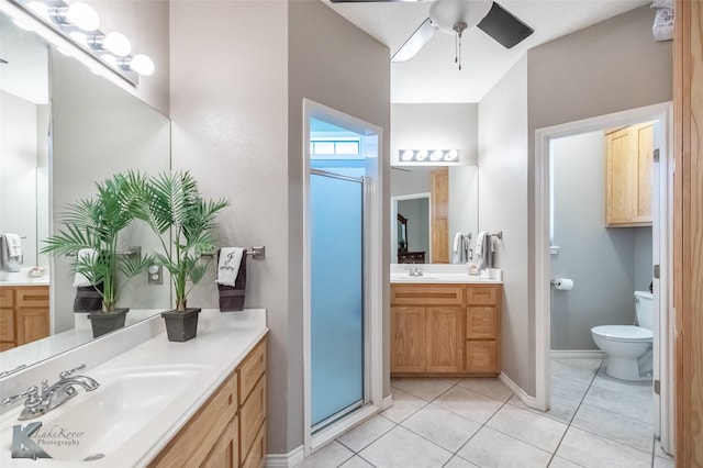 109 Fry Blvd, Tuscola, TX 79562 - bathroom featuring a stall shower, tile patterned floors, two vanities, a ceiling fan, and toilet