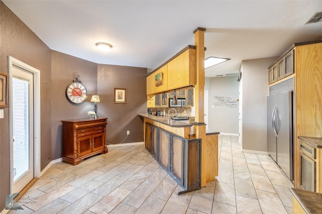 109 Fry Blvd, Tuscola, TX 79562 - kitchen with stainless steel appliances, a peninsula, a sink, baseboards, and light marble finish floors