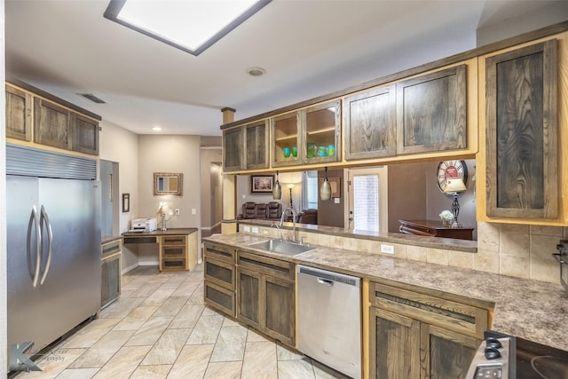 109 Fry Blvd, Tuscola, TX 79562 - kitchen with appliances with stainless steel finishes, a sink, recessed lighting, tasteful backsplash, and glass insert cabinets