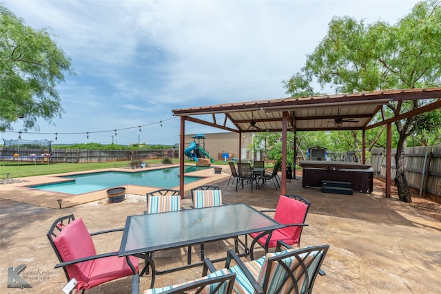 109 Fry Blvd, Tuscola, TX 79562 - view of patio / terrace with a hot tub, a ceiling fan, outdoor dining space, a fenced backyard, and a gazebo