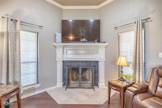 109 Fry Blvd, Tuscola, TX 79562 - living room with a tiled fireplace, ornamental molding, light wood-style flooring, and baseboards