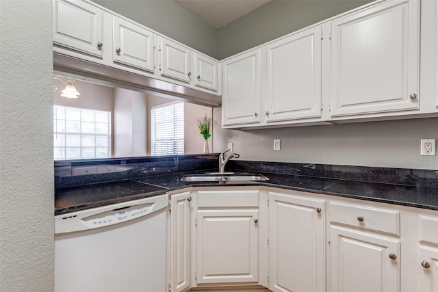 6000 Auburndale Ave Unit E, University Park, TX 75205 - kitchen featuring white dishwasher, a sink, white cabinetry, and a textured wall
