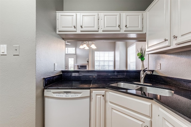 6000 Auburndale Ave Unit E, University Park, TX 75205 - kitchen with dishwasher, a textured wall, a sink, white cabinetry, and a chandelier