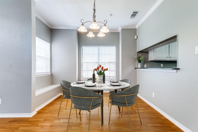 6000 Auburndale Ave Unit E, University Park, TX 75205 - dining area featuring ornamental molding, a chandelier, light wood finished floors, and baseboards