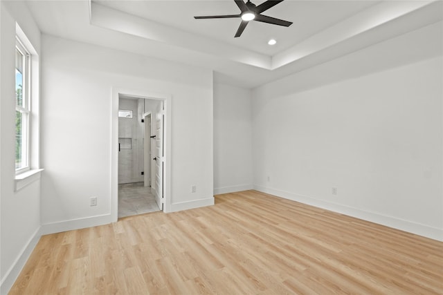 2534 Pennsylvania Ave, Dallas, TX 75215 - unfurnished bedroom featuring a raised ceiling, light wood-style floors, baseboards, recessed lighting, and ensuite bath