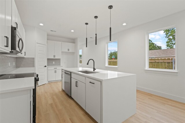 2534 Pennsylvania Ave, Dallas, TX 75215 - kitchen featuring stainless steel appliances, a sink, healthy amount of natural light, tasteful backsplash, and recessed lighting