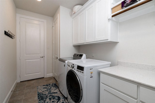 1100 Whisper Willows Dr, Fort Worth, TX 76052 - laundry area with cabinet space, washing machine and dryer, baseboards, and stone finish floors