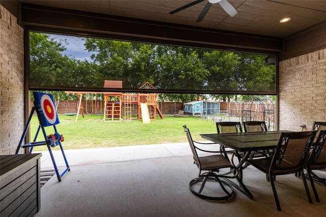 1100 Whisper Willows Dr, Fort Worth, TX 76052 - view of patio / terrace with a playground, a storage unit, outdoor dining area, an outdoor structure, and a ceiling fan