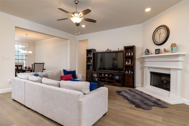 1100 Whisper Willows Dr, Fort Worth, TX 76052 - living room featuring wood finished floors, a chandelier, a ceiling fan, crown molding, and a fireplace with raised hearth